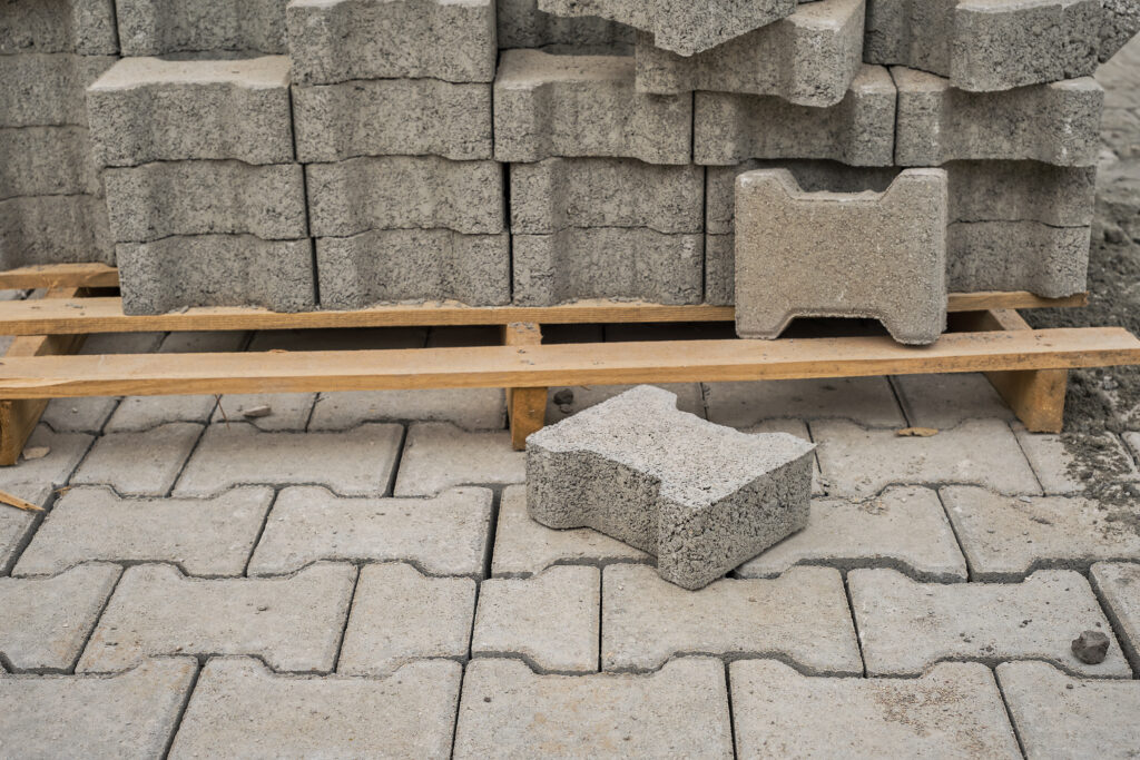 paving slabs stacked on a pallet, road repair process, close up, selective focus on tiles, seasonal reconstruction of pavement in walking paths in parks paving slabs stacked on a pallet, road repair process, close up, selective focus on tiles, seasonal reconstruction of pavement in walking paths in parks